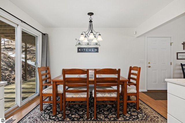 dining room with a chandelier and light wood-style flooring