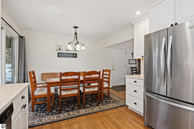dining room featuring light wood-type flooring, an inviting chandelier, and recessed lighting