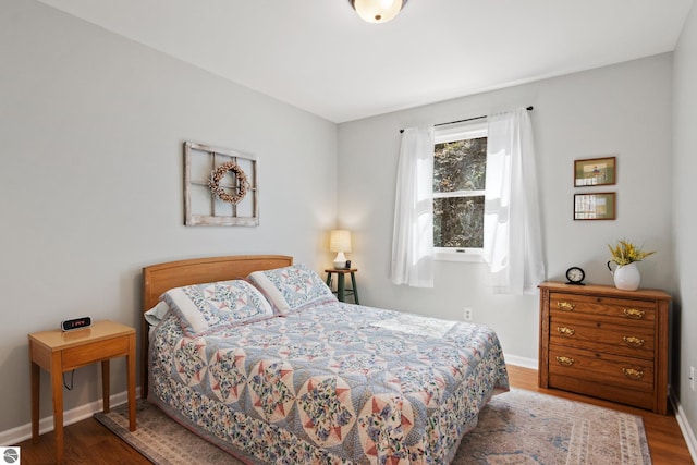 bedroom featuring baseboards and wood finished floors
