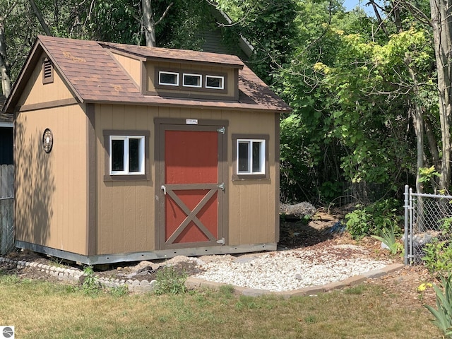 view of shed featuring fence