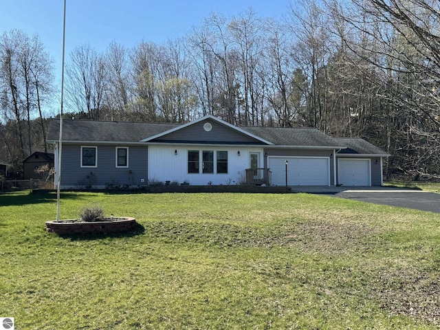 ranch-style house featuring a garage, driveway, and a front lawn