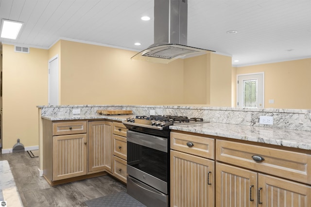 kitchen featuring crown molding, island exhaust hood, dark wood finished floors, and stainless steel gas range oven
