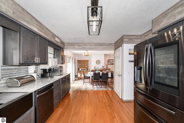 4631 Cardinal Dr, Mount Pleasant, MI 48858 - kitchen featuring stainless steel dishwasher, light wood-type flooring, a textured ceiling, refrigerator with ice dispenser, and a chandelier