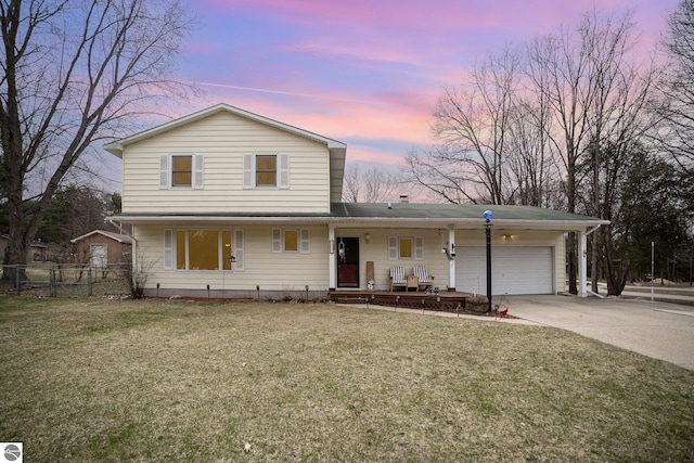 4631 Cardinal Dr, Mount Pleasant, MI 48858 - traditional home with an attached garage, concrete driveway, fence, and a lawn