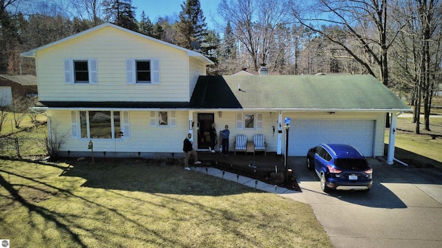 4631 Cardinal Dr, Mount Pleasant, MI 48858 - traditional-style home with a chimney, driveway, an attached garage, a front yard, and a porch