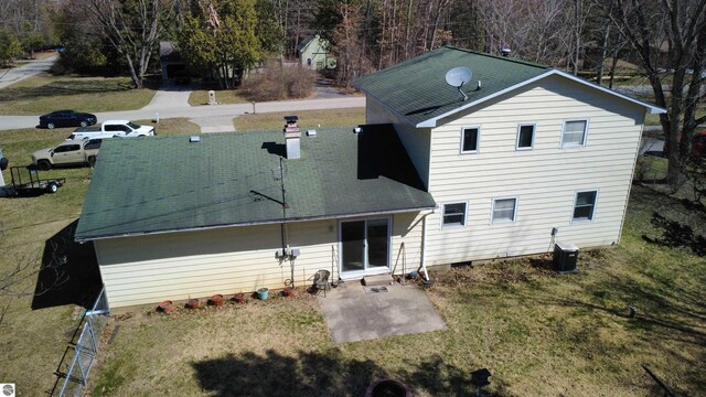 4631 Cardinal Dr, Mount Pleasant, MI 48858 - back of house with a patio area, central AC unit, a lawn, and a chimney