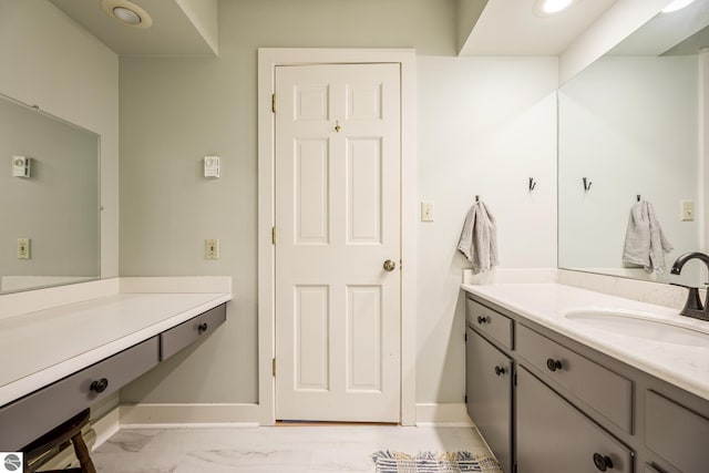 3862 N Trillium Dr, Leland, MI 49654 - bathroom with marble finish floor, vanity, and baseboards