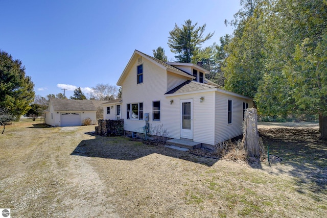 view of front of property with an outdoor structure