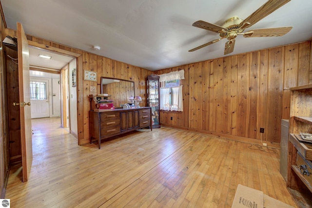 bedroom featuring light wood-style floors and wood walls