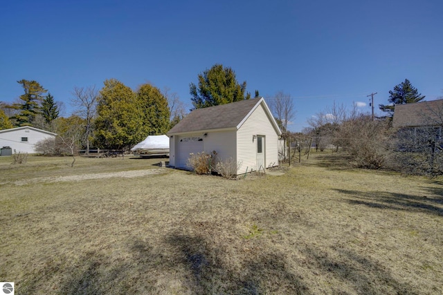 view of property exterior with a yard and an outbuilding