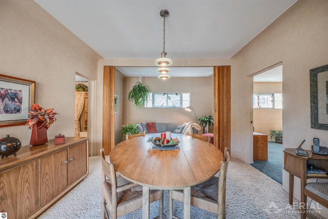 dining room featuring light colored carpet