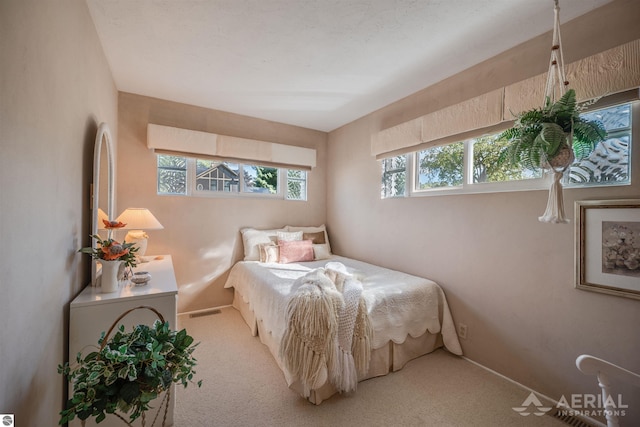 carpeted bedroom with baseboards and visible vents