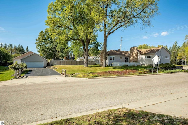 single story home with a front yard, a garage, and fence