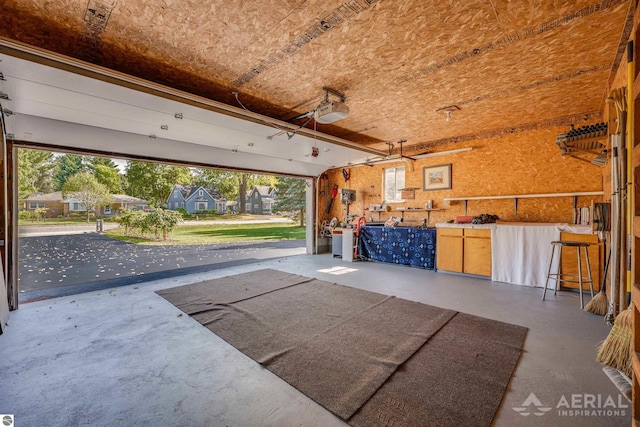 garage with a garage door opener and a workshop area