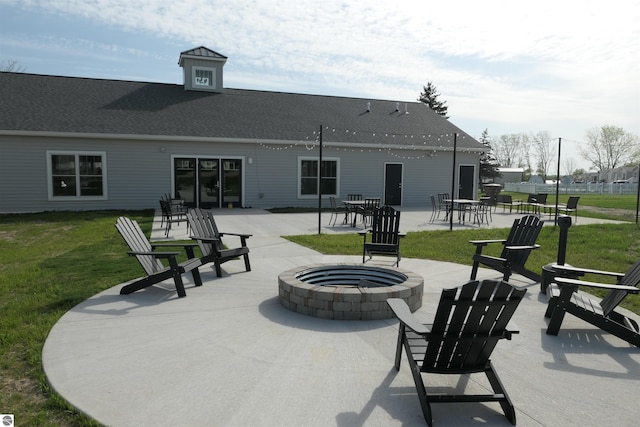 1279 Beacon Hill Ct, Mount Pleasant, MI 48858 - exterior space featuring an outdoor fire pit, a patio, roof with shingles, and a lawn