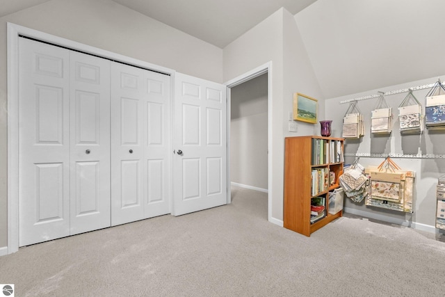 2127 E Timberlane Dr, Traverse City, MI 49686 - carpeted bedroom featuring a closet, baseboards, and vaulted ceiling
