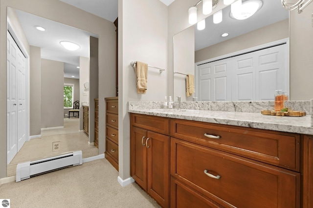 2127 E Timberlane Dr, Traverse City, MI 49686 - bathroom with a baseboard heating unit, baseboards, and vanity