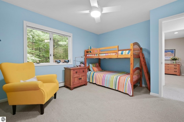 2127 E Timberlane Dr, Traverse City, MI 49686 - bedroom with carpet flooring, baseboard heating, baseboards, and ceiling fan