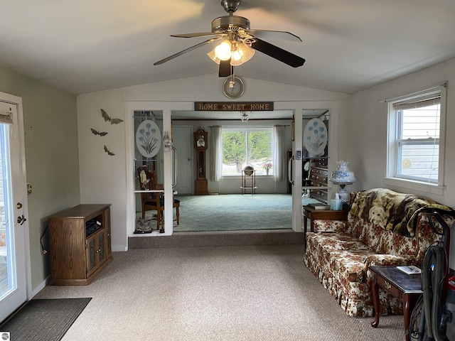 carpeted living room featuring lofted ceiling and ceiling fan