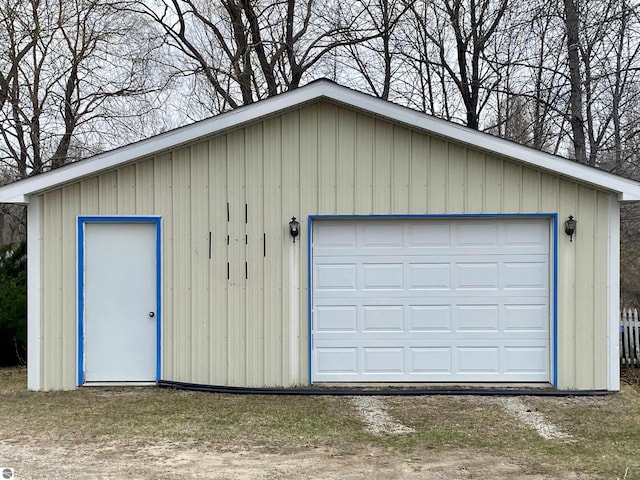 detached garage with dirt driveway