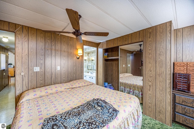 bedroom with wood walls and a ceiling fan