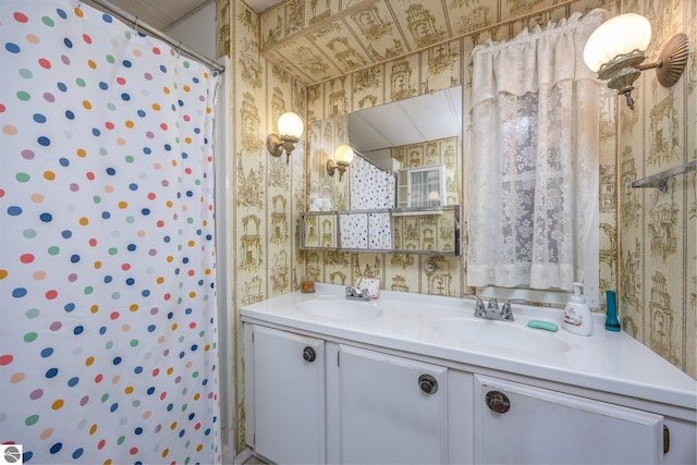full bathroom with wallpapered walls, double vanity, a sink, and a shower with shower curtain