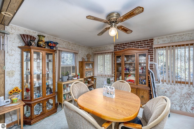 dining room featuring wallpapered walls and a ceiling fan