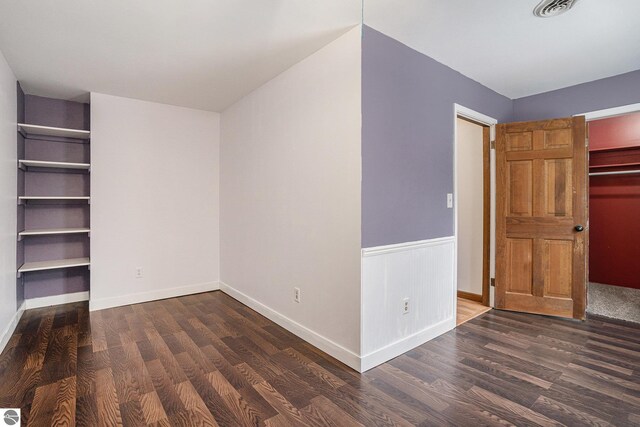 4676 W Mcmillan Rd, Muskegon, MI 49445 - unfurnished bedroom with baseboards and wood finished floors