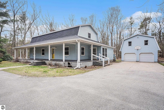 4676 W Mcmillan Rd, Muskegon, MI 49445 - farmhouse inspired home with a gambrel roof, covered porch, a detached garage, an outdoor structure, and roof with shingles