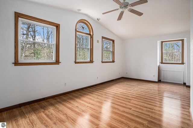 4676 W Mcmillan Rd, Muskegon, MI 49445 - unfurnished room featuring light wood-type flooring, ceiling fan, baseboards, and lofted ceiling