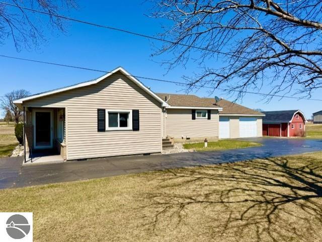 1705 S State Rd, Ithaca, MI 48847 - exterior space with a lawn, an outbuilding, crawl space, and a detached garage