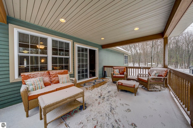 snow covered patio with an outdoor living space