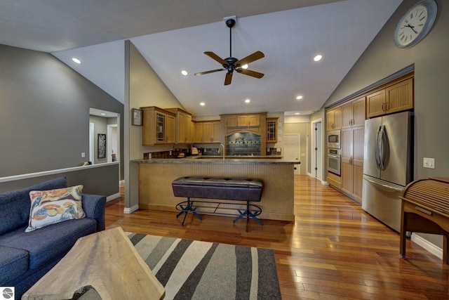 living room featuring light wood-style floors, ceiling fan, and lofted ceiling