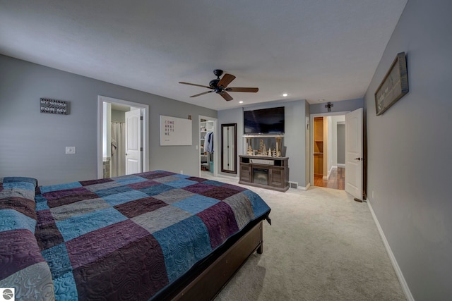 carpeted bedroom featuring ensuite bathroom, baseboards, recessed lighting, and ceiling fan