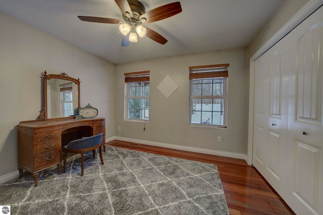 office area with baseboards, a ceiling fan, and wood finished floors