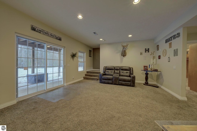 carpeted living room featuring visible vents, baseboards, recessed lighting, and stairs