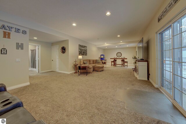 living room with light carpet, recessed lighting, and baseboards