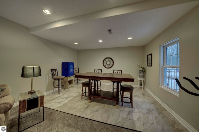 dining room with baseboards and recessed lighting