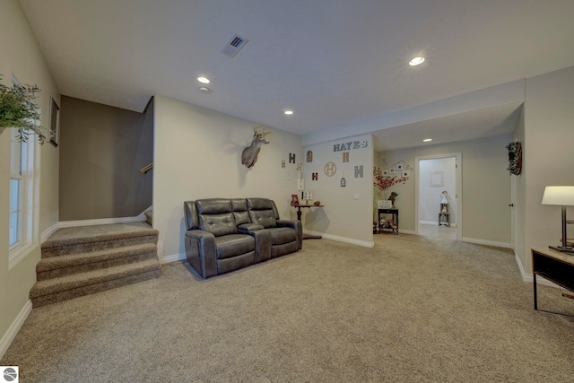 living room featuring recessed lighting, carpet, visible vents, and stairs