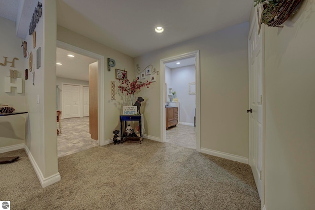 hallway with carpet floors, baseboards, and recessed lighting