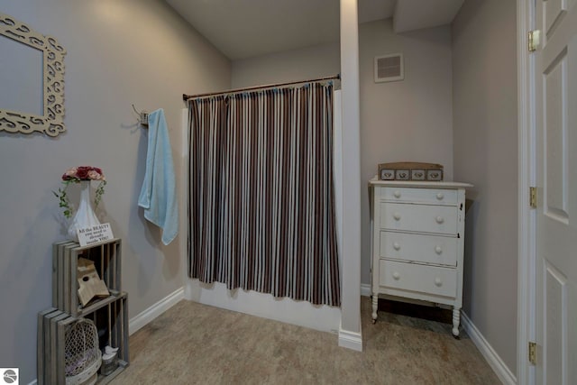 bathroom with curtained shower, baseboards, and visible vents