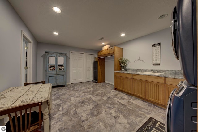 kitchen featuring range, a sink, light countertops, and recessed lighting