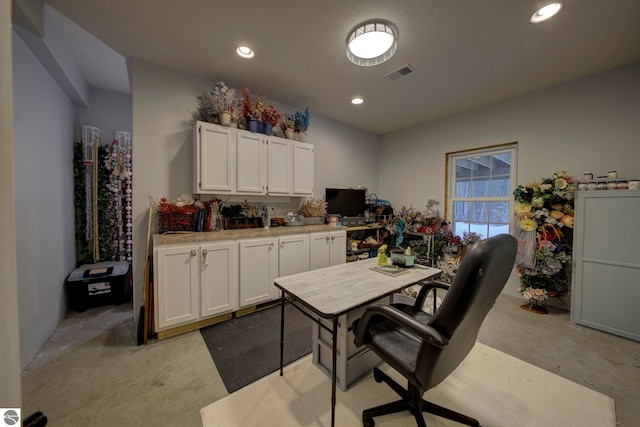 office featuring visible vents, recessed lighting, and light carpet