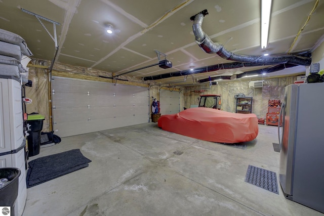 garage featuring a garage door opener and freestanding refrigerator
