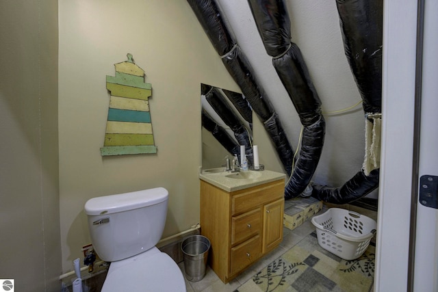 bathroom with tile patterned flooring, vanity, and toilet