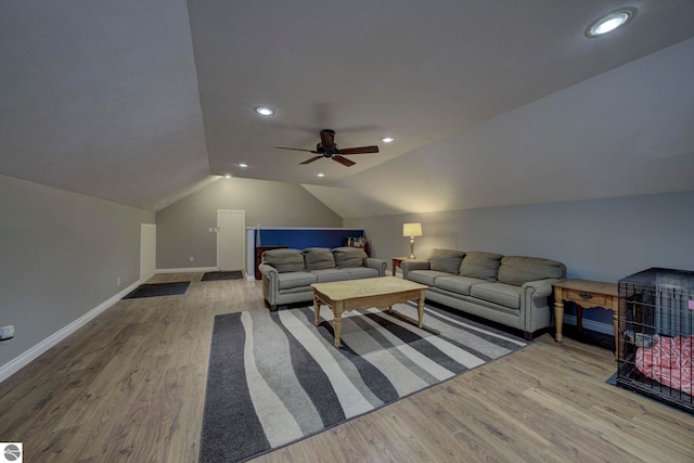 living room with a ceiling fan, recessed lighting, wood finished floors, lofted ceiling, and baseboards