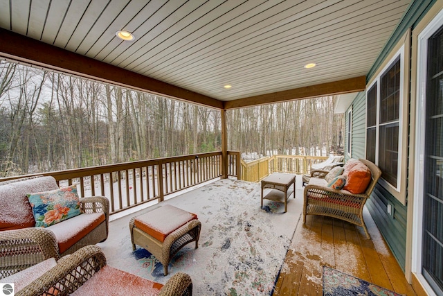 view of patio / terrace with an outdoor living space and a view of trees