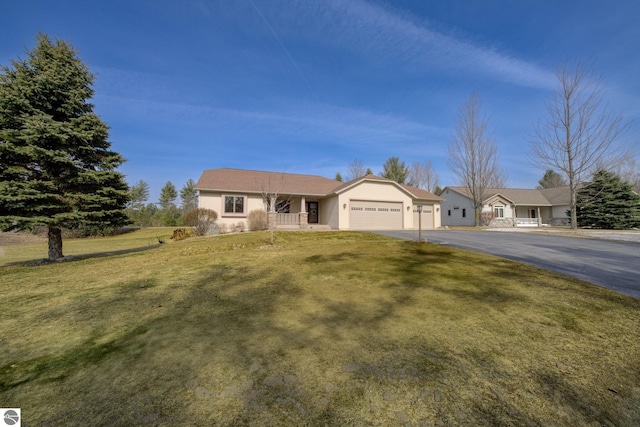 1339 Killdeer Ln, Kingsley, MI 49649 - ranch-style house featuring aphalt driveway, an attached garage, and a front yard