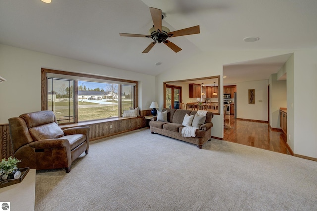 1339 Killdeer Ln, Kingsley, MI 49649 - living area featuring carpet floors, baseboards, a ceiling fan, and lofted ceiling