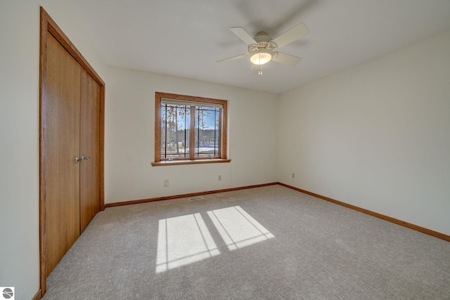 1339 Killdeer Ln, Kingsley, MI 49649 - unfurnished bedroom with a closet, baseboards, visible vents, ceiling fan, and carpet floors